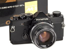 Olympus M1 black paint 1972 front with box in background